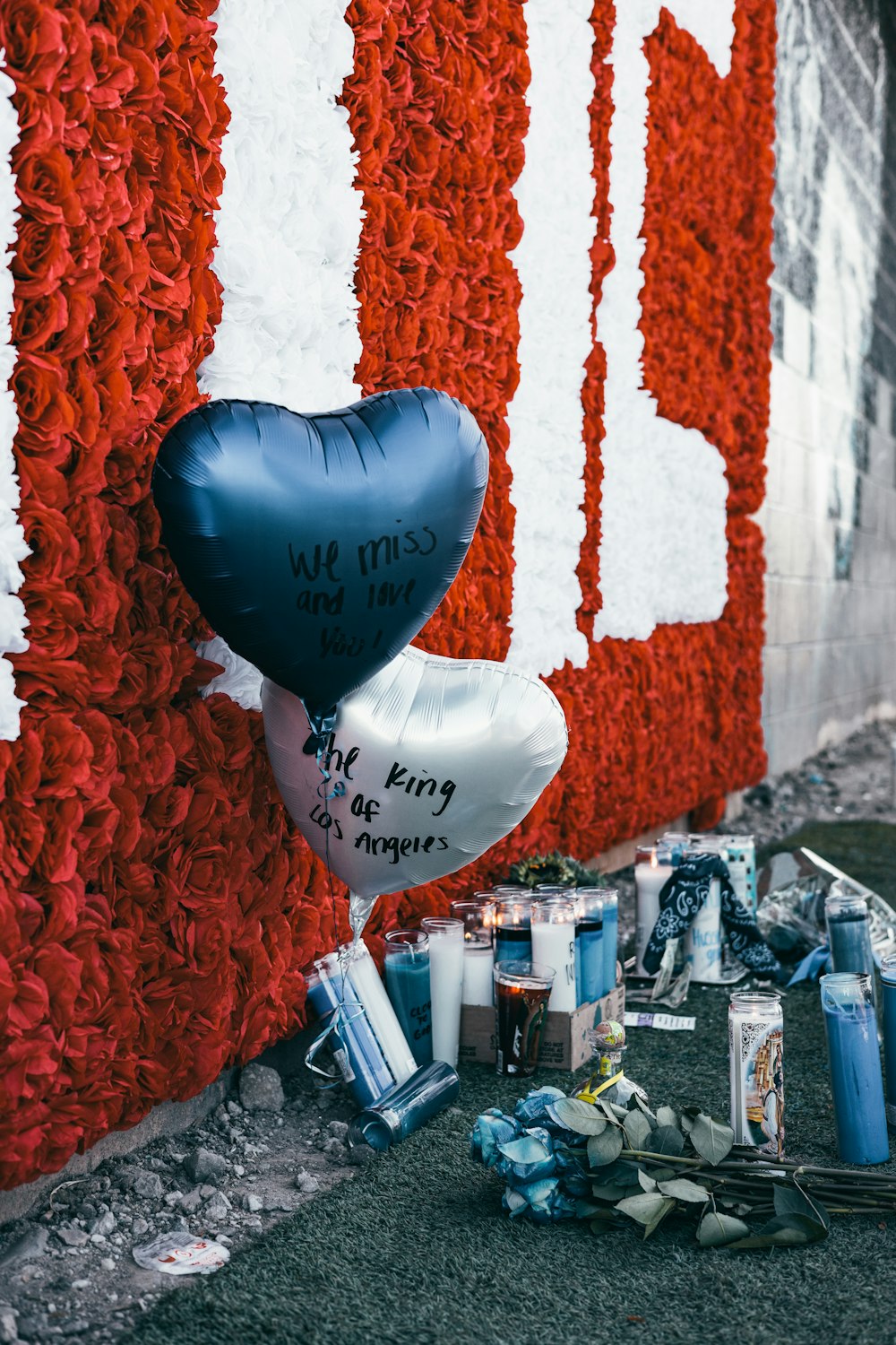 blue balloon near white and red plastic bottles