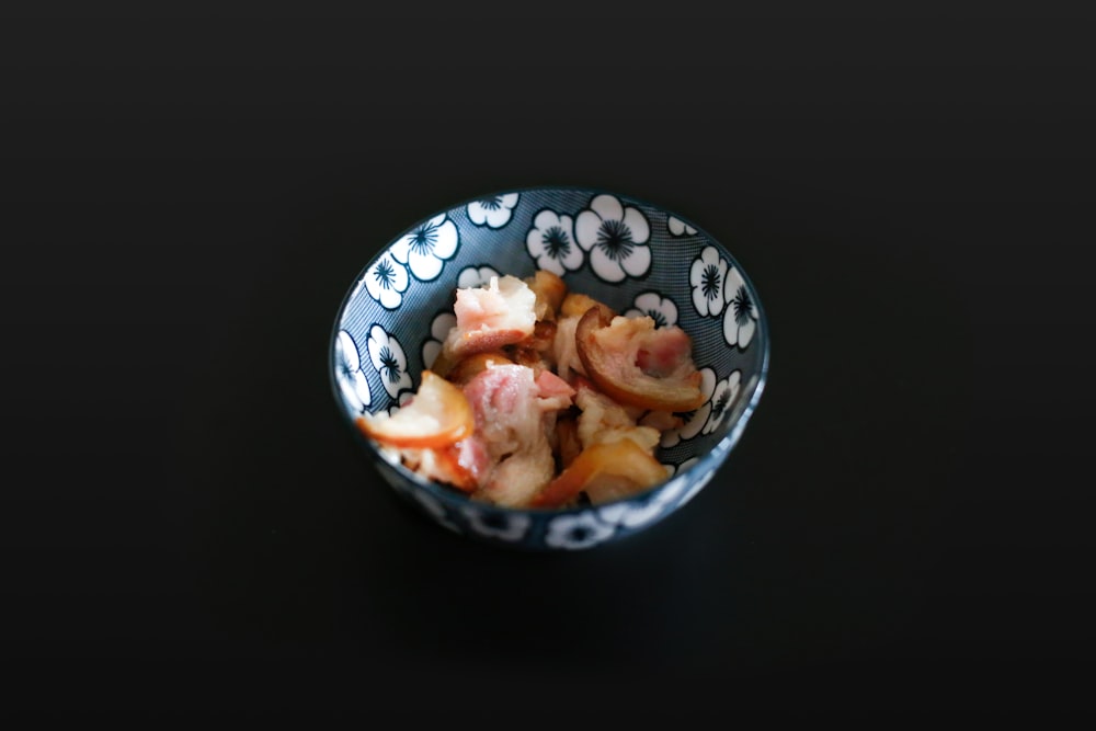 sliced meat on blue and white ceramic bowl