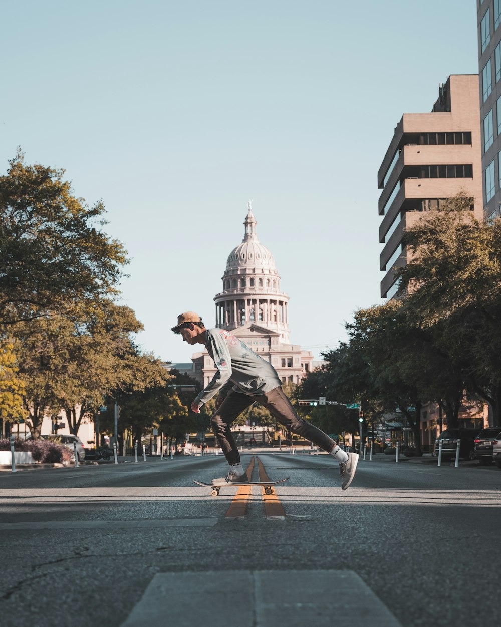 man riding on horse statue in the middle of the city during daytime