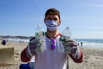 man in white shirt holding bottled water