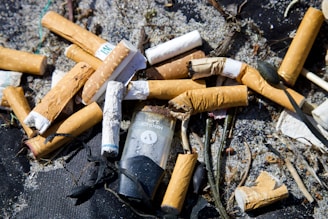 white and brown cigarette butts on black textile