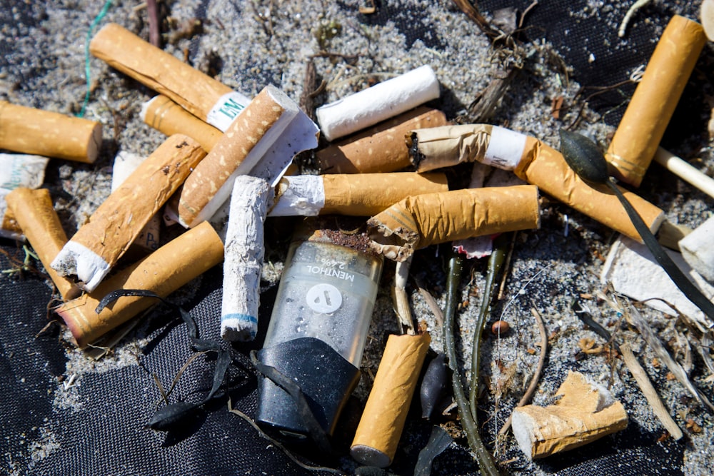 white and brown cigarette butts on black textile