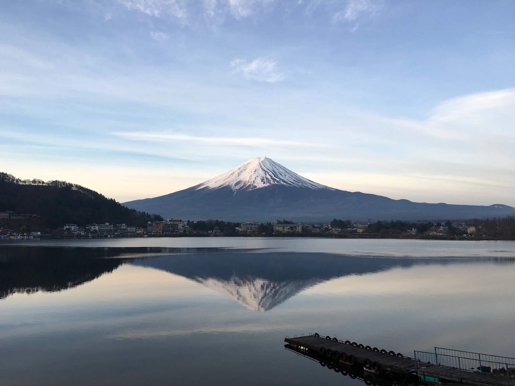 Mount Fuji above a still lake at dawn