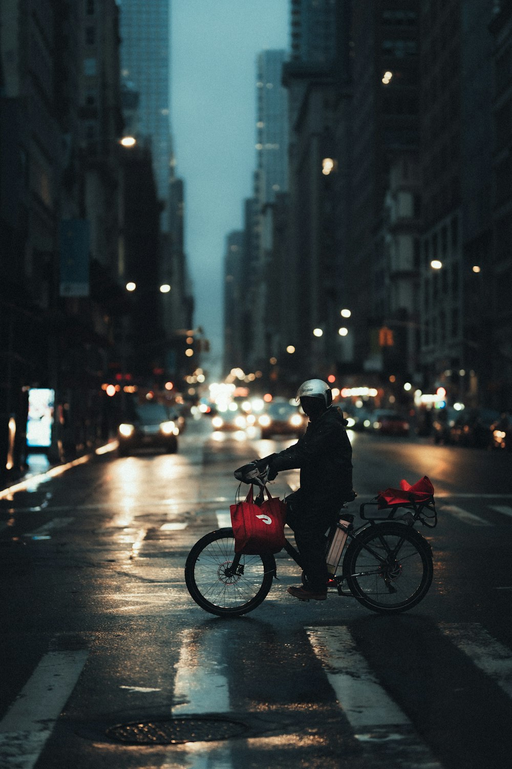 man in black jacket riding red motorcycle on road during daytime
