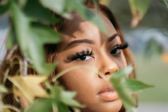 womans face on green leaves