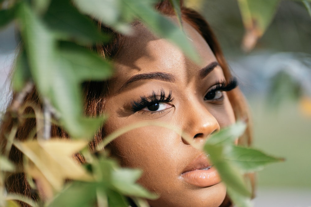 womans face on green leaves