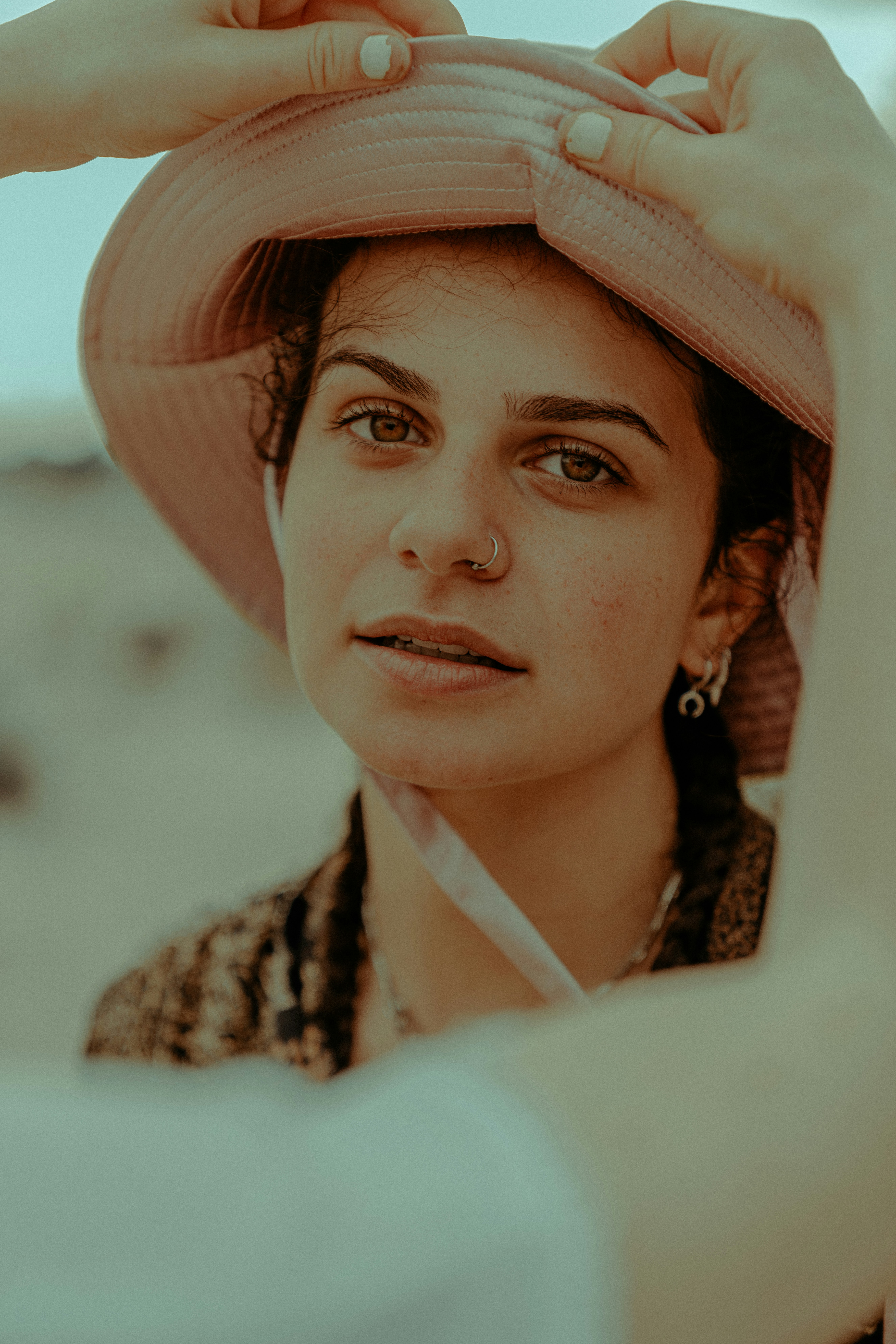 woman in brown and black knit hat