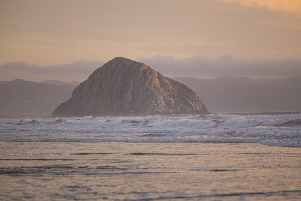 brown rock formation on sea during daytime