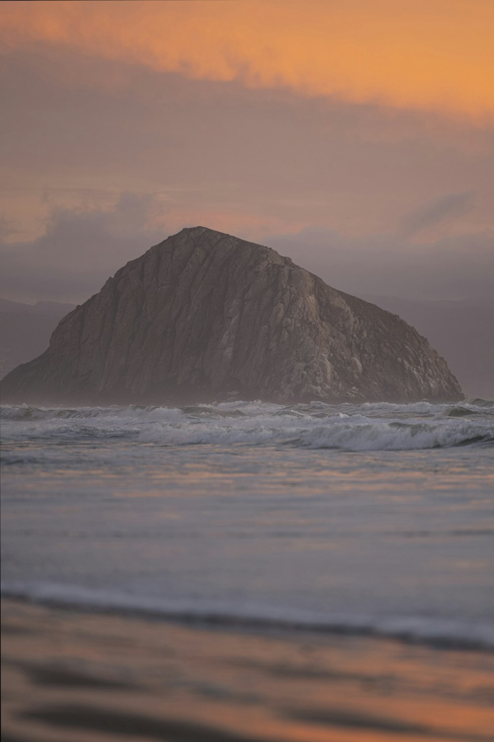 gray rock formation on sea water during daytime