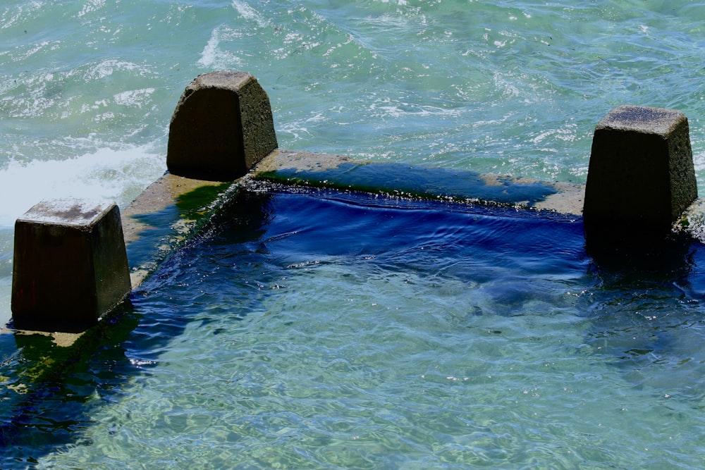 brown concrete dock on blue body of water during daytime