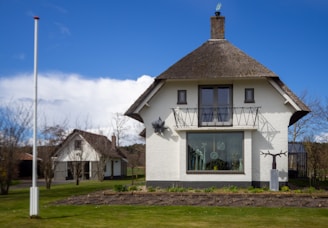 white concrete house on green grass field during daytime
