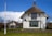 white concrete house on green grass field during daytime
