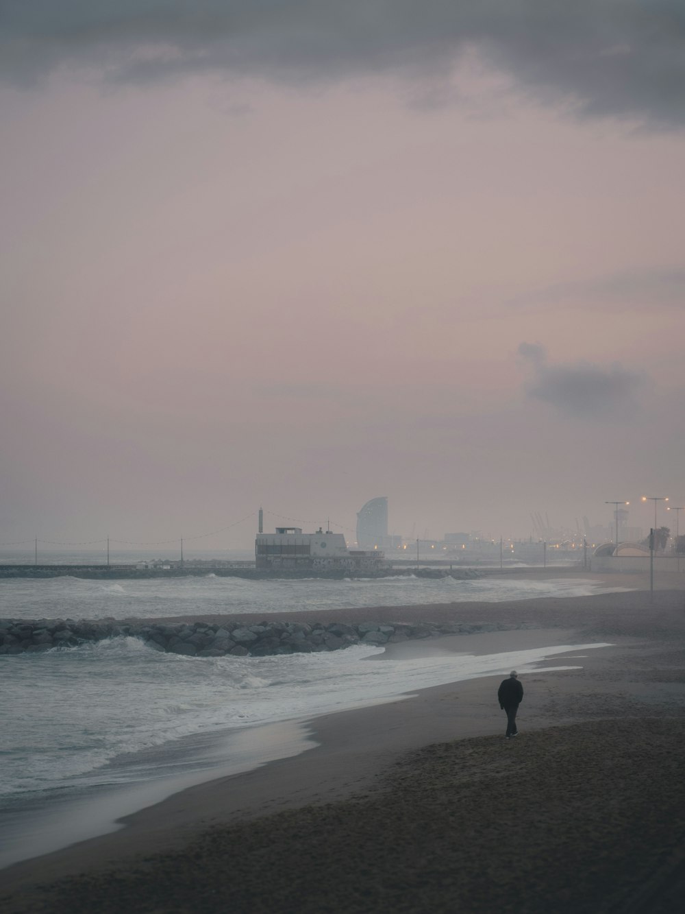 person walking on beach during daytime