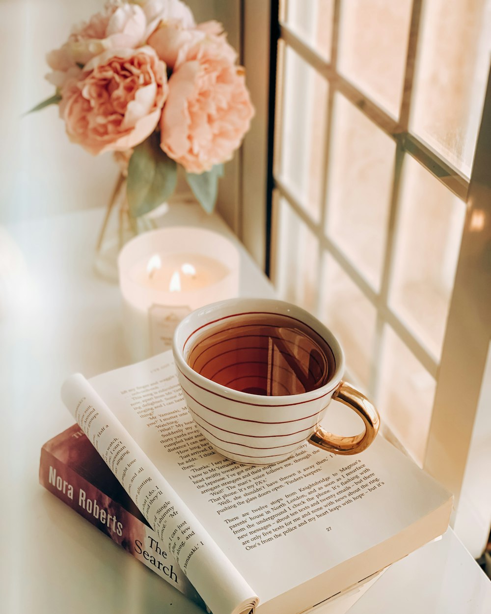 white ceramic mug on book page