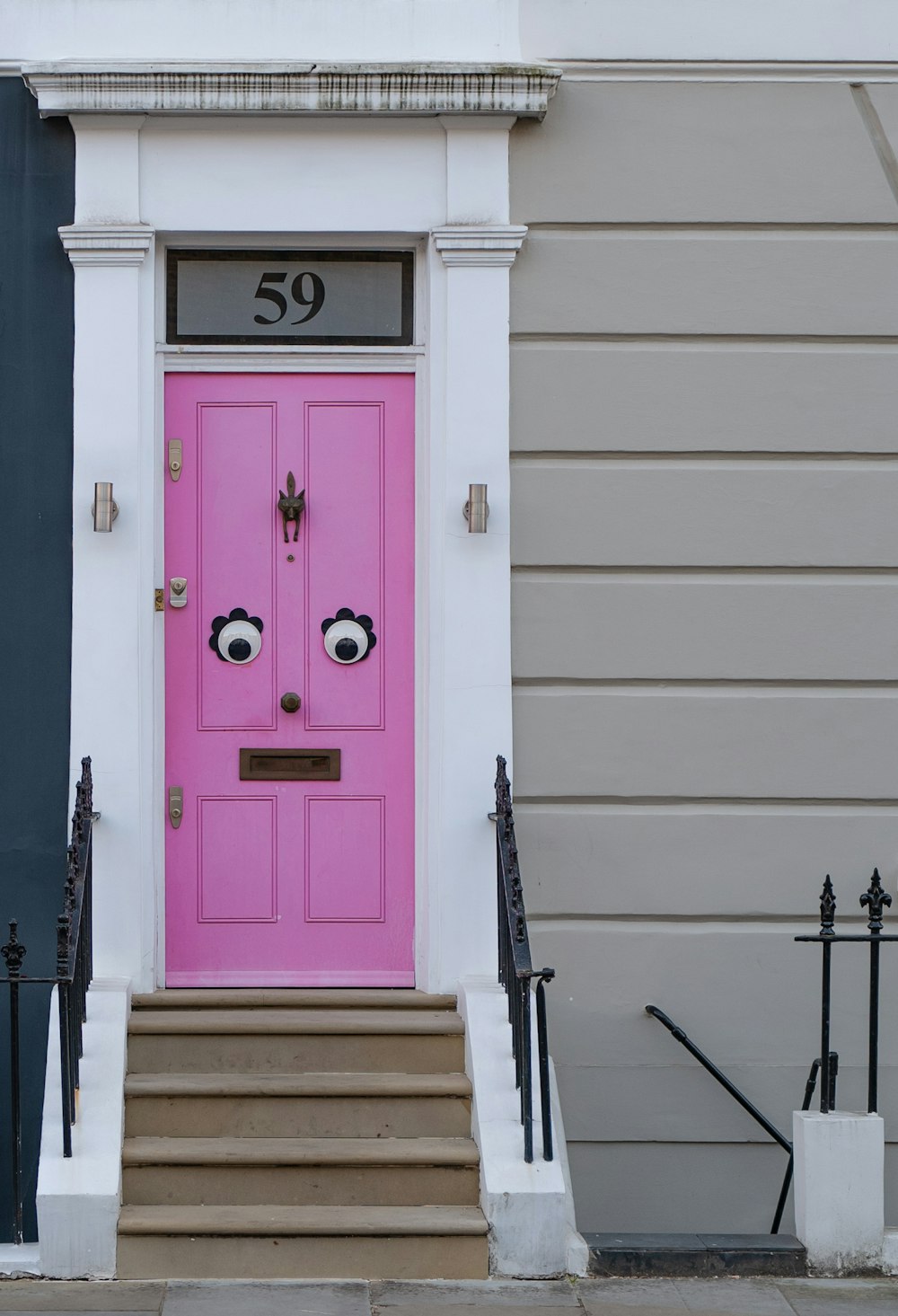 purple wooden door on white concrete wall