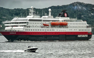 A friendly travel agent assisting a customer with ferry booking on a laptop