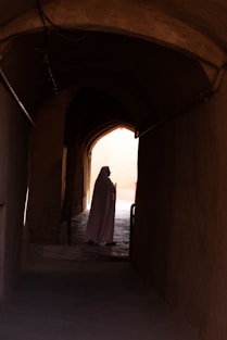 woman in white dress walking on hallway during daytime