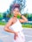 A woman with braided hair styled in an updo is standing outdoors. She is wearing a white, one-shoulder top and light-colored pants. Her pose appears confident, and she seems to be looking off into the distance. The background features blurred natural elements such as trees and greenery, suggesting a park or garden setting.