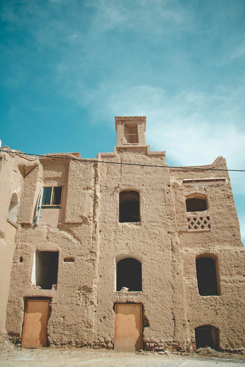 brown concrete building under blue sky during daytime