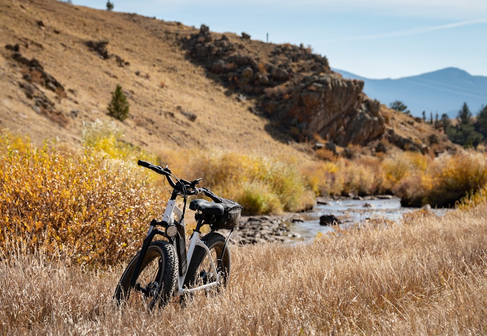 black motorcycle on brown grass field during daytime