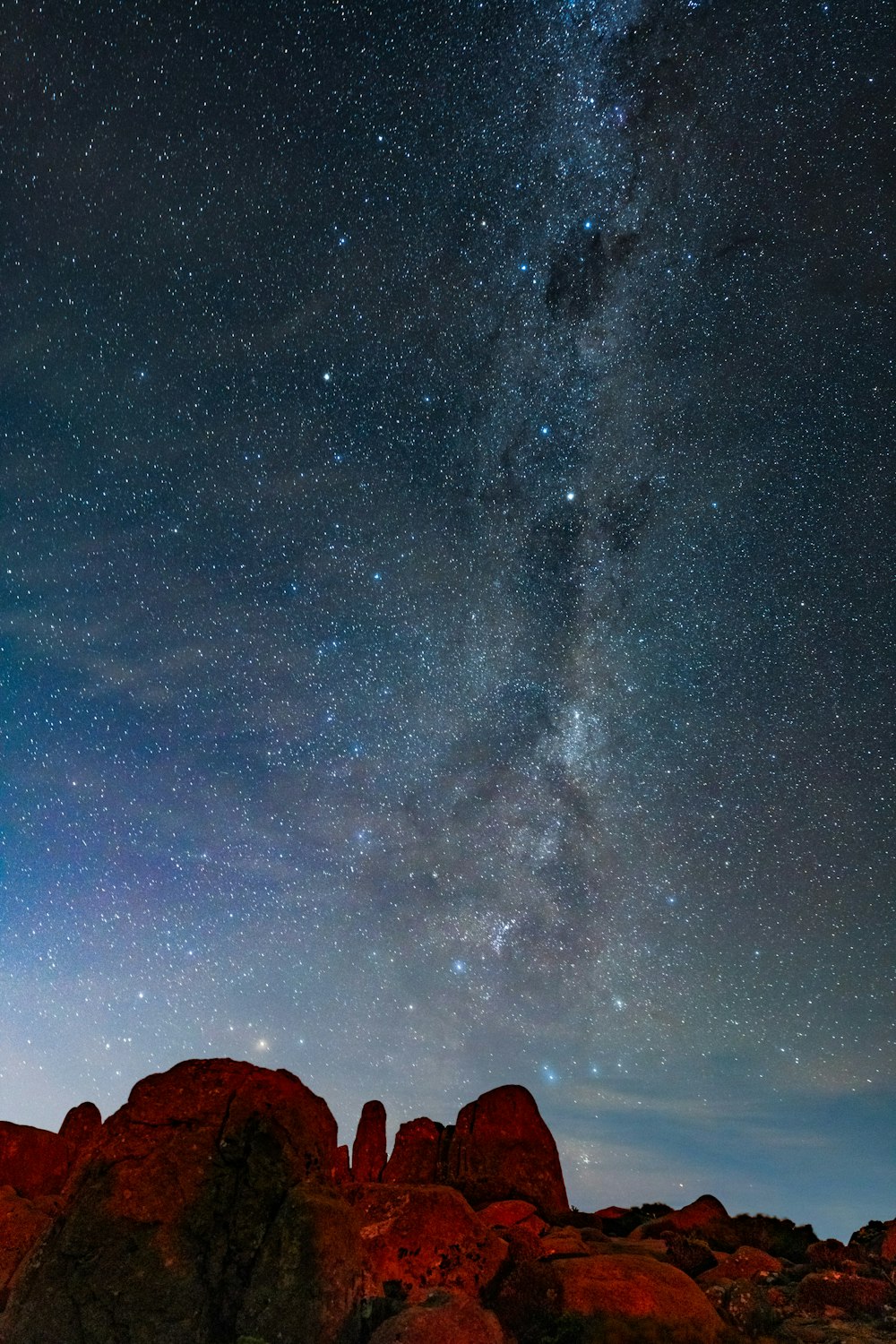 silhouette of mountain under starry night