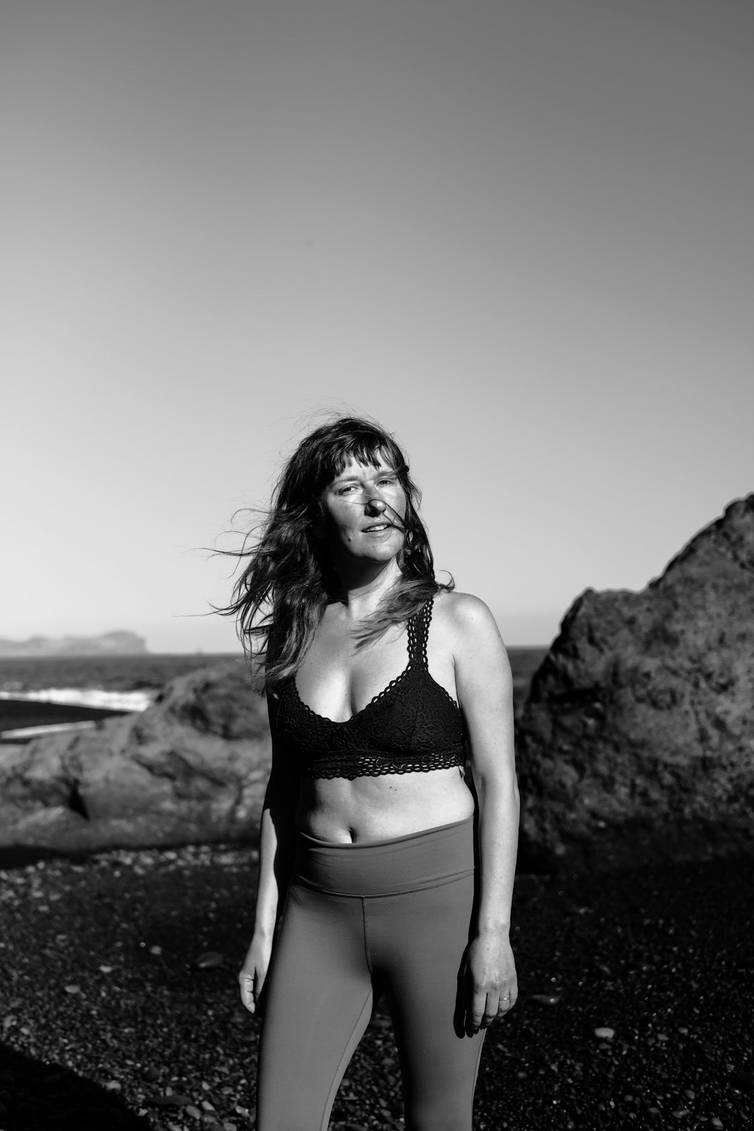 woman in bikini standing on rock