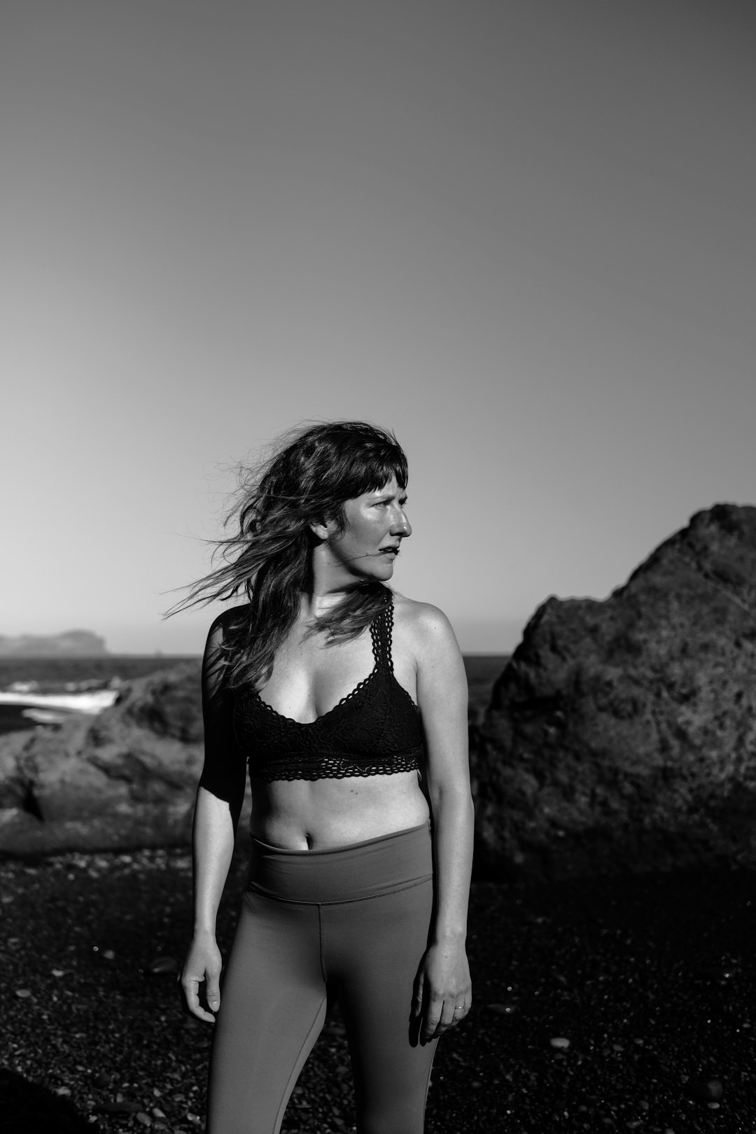 woman in bikini standing on rock