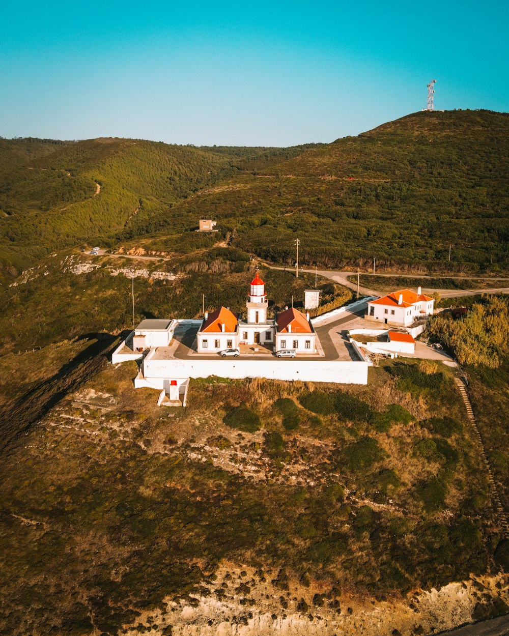 white and brown house on top of hill