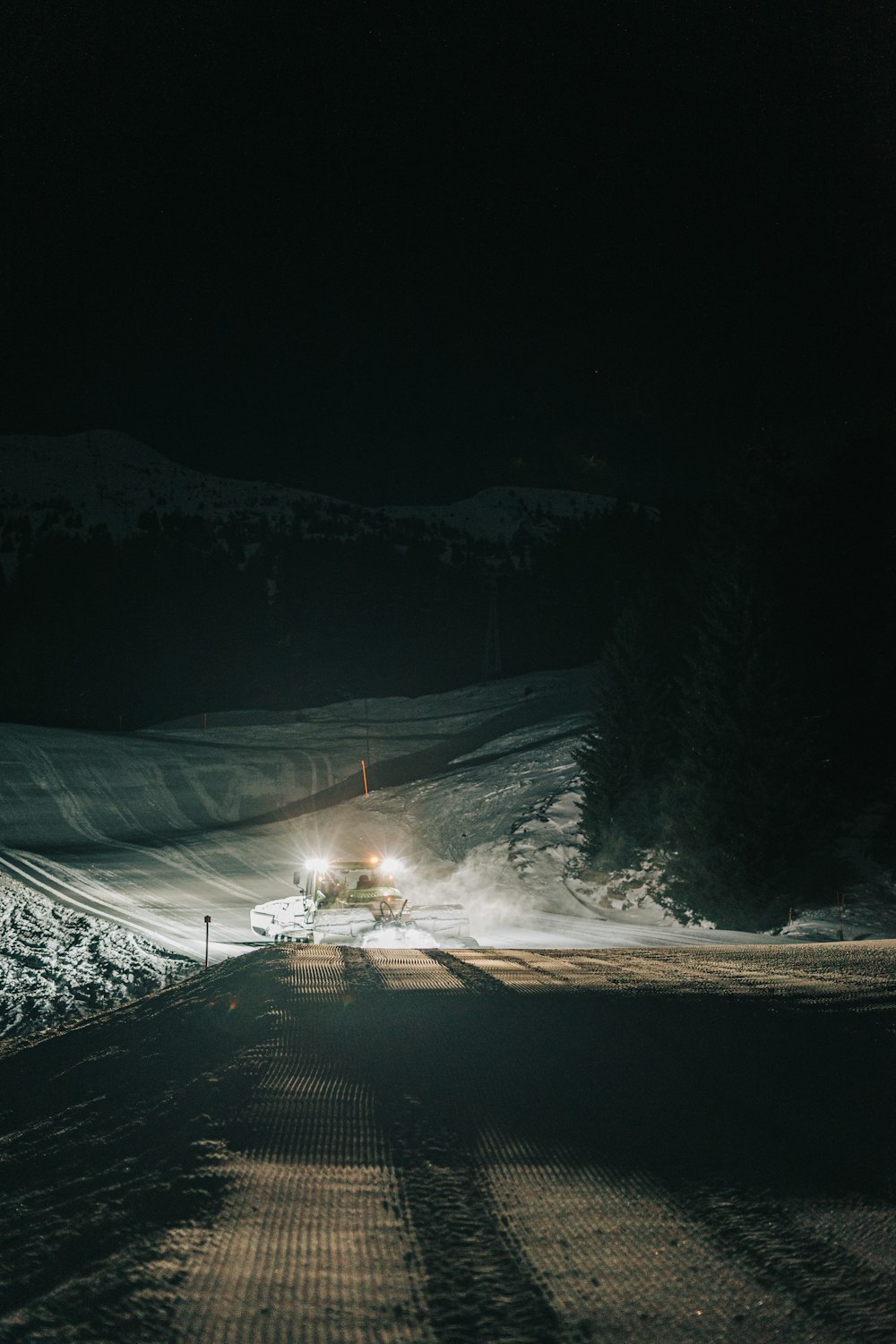snow covered road during night time
