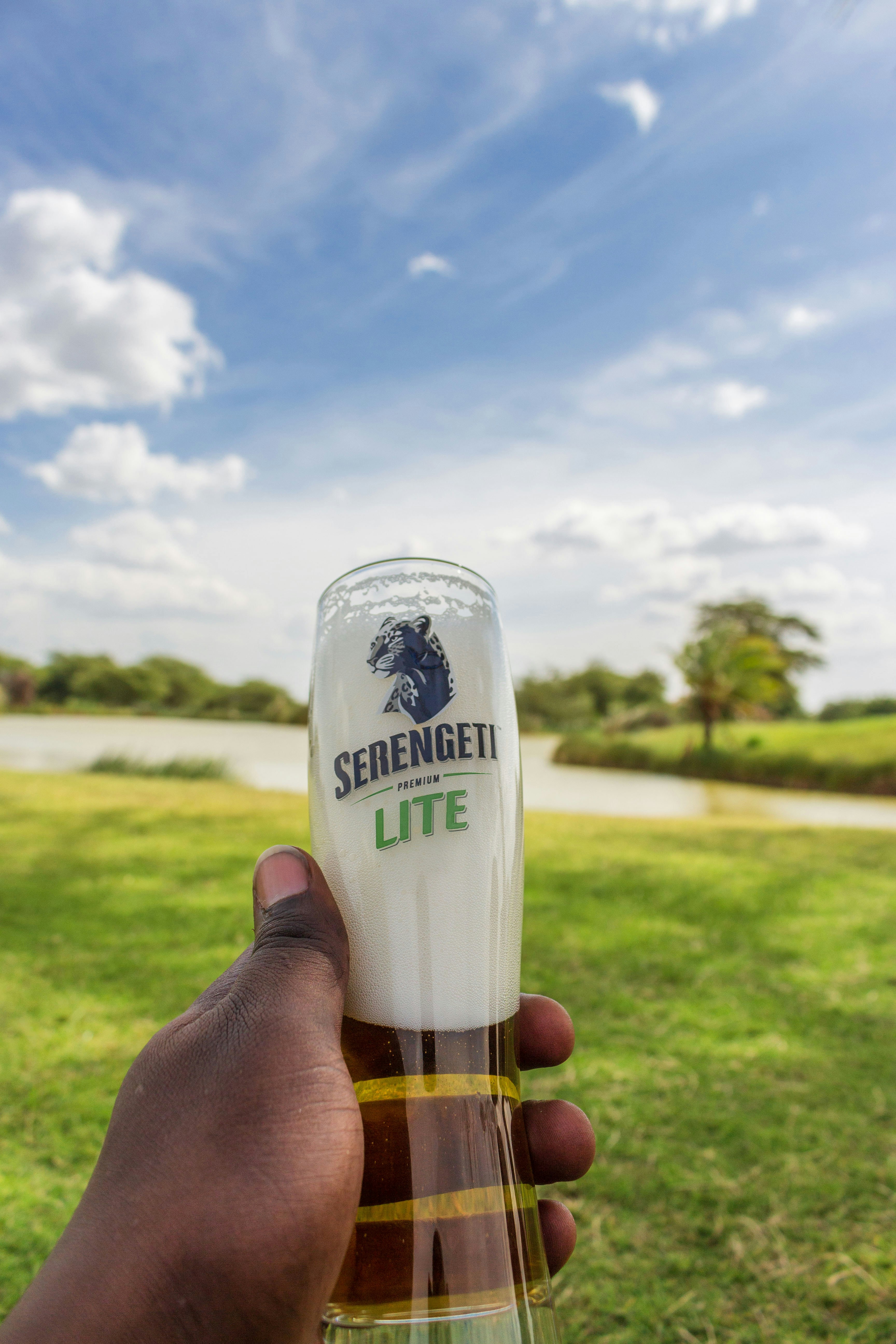 Enjoying a cold Serengeti premier beer on a sunny day.