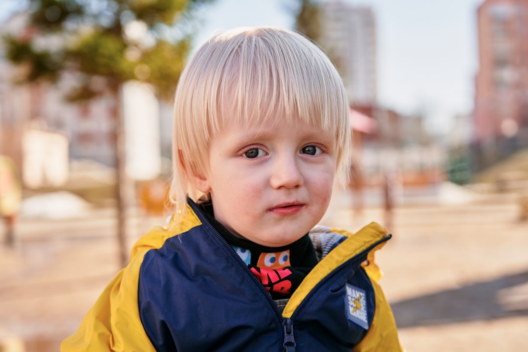 boy in blue and yellow zip up jacket