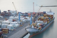Workers inspecting goods at a busy international port.