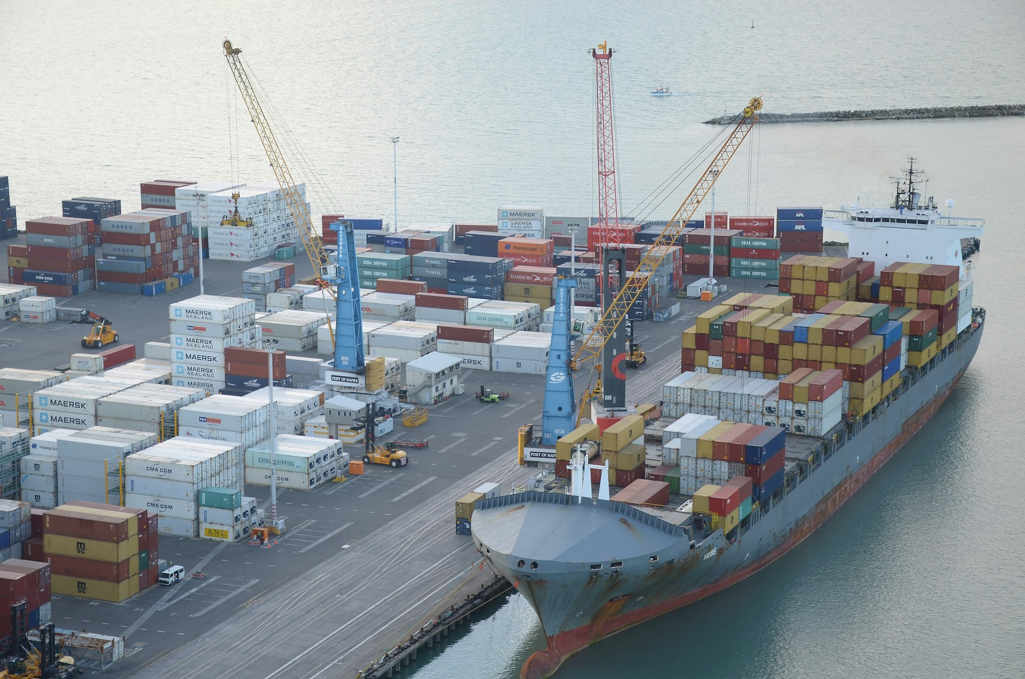 Cargo ship being loaded at a wharf