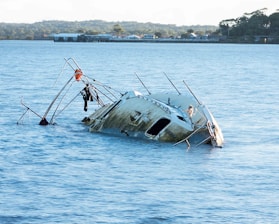 gray and white boat on sea during daytime