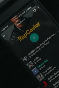 a close up of a cell phone with rapcaviar on the screen