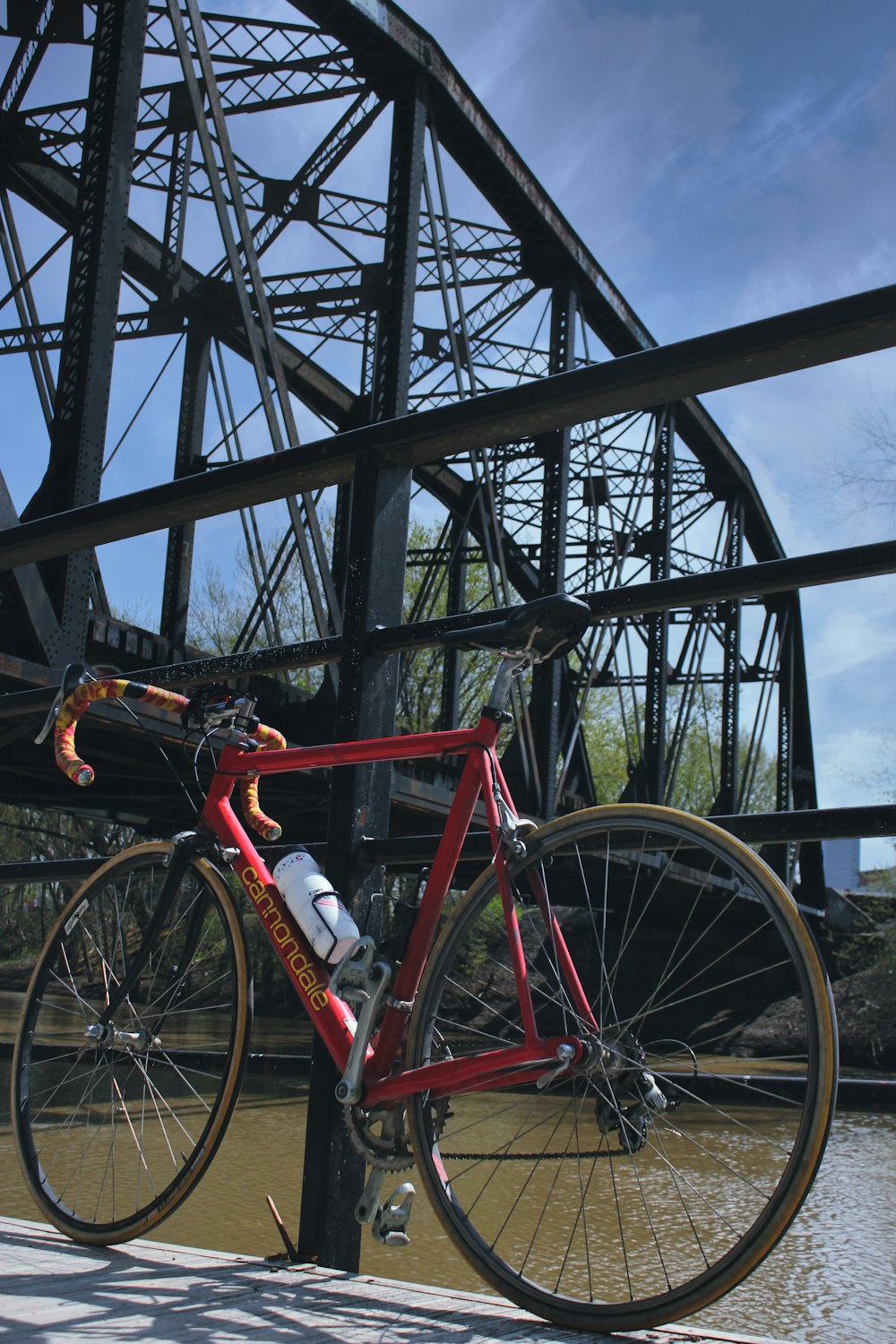 red and white bicycle on bridge