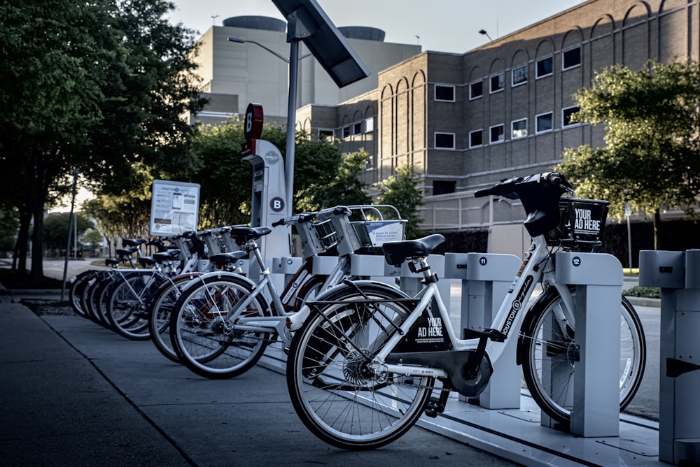 black and silver bicycle parked on sidewalk during daytime