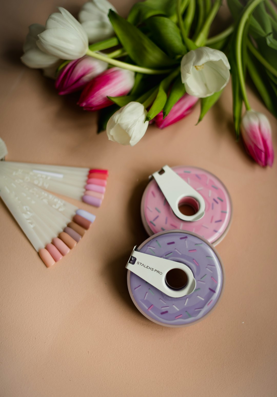 pink and white cd on pink textile