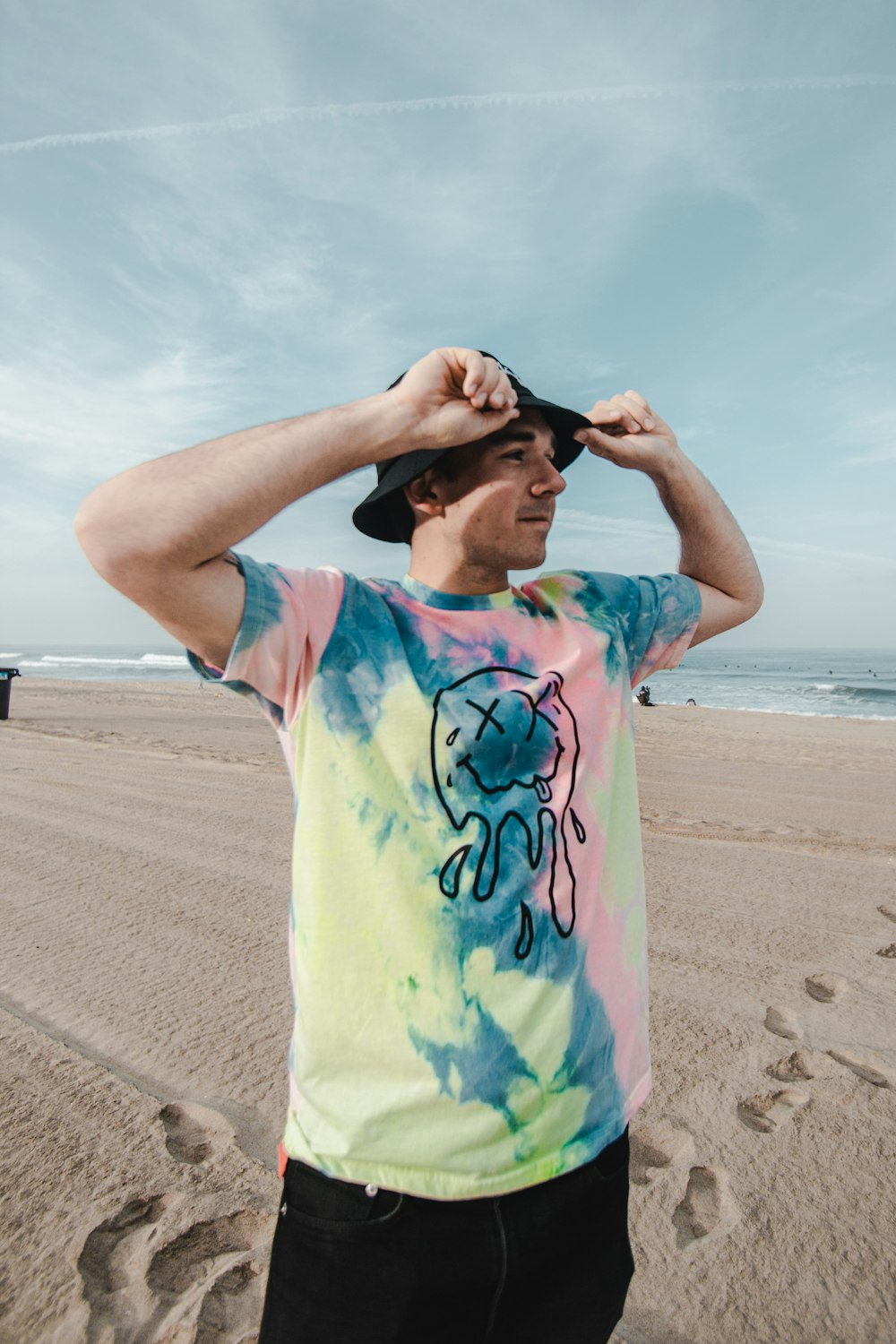 man in blue and yellow t-shirt standing on beach during daytime