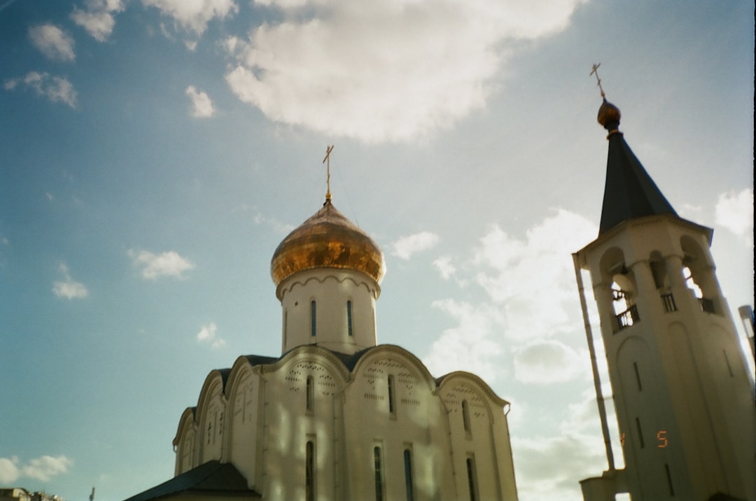 white and brown concrete church under blue sky during daytime