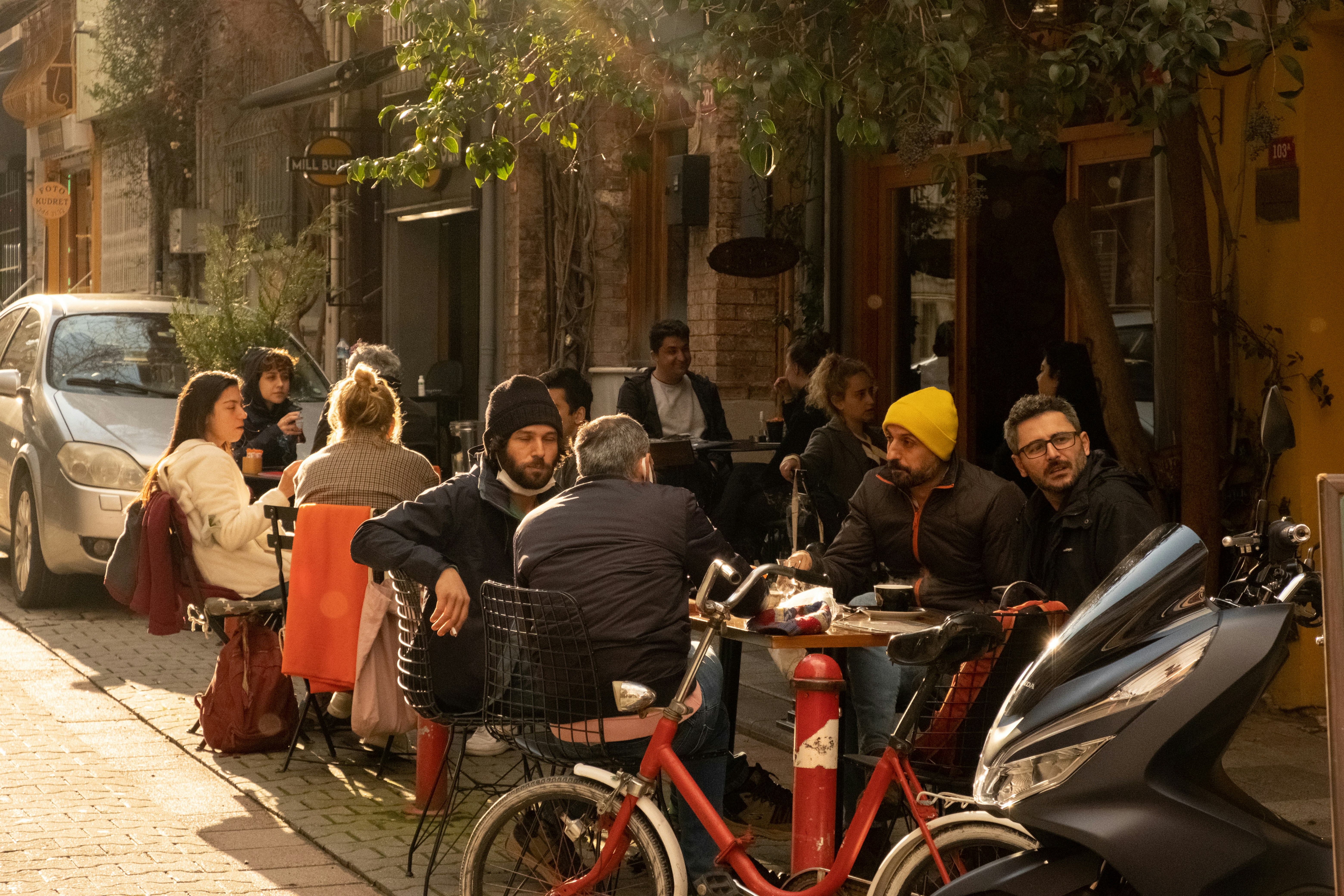 people sitting outside of the restaurant talking