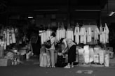 grayscale photo of people in a market