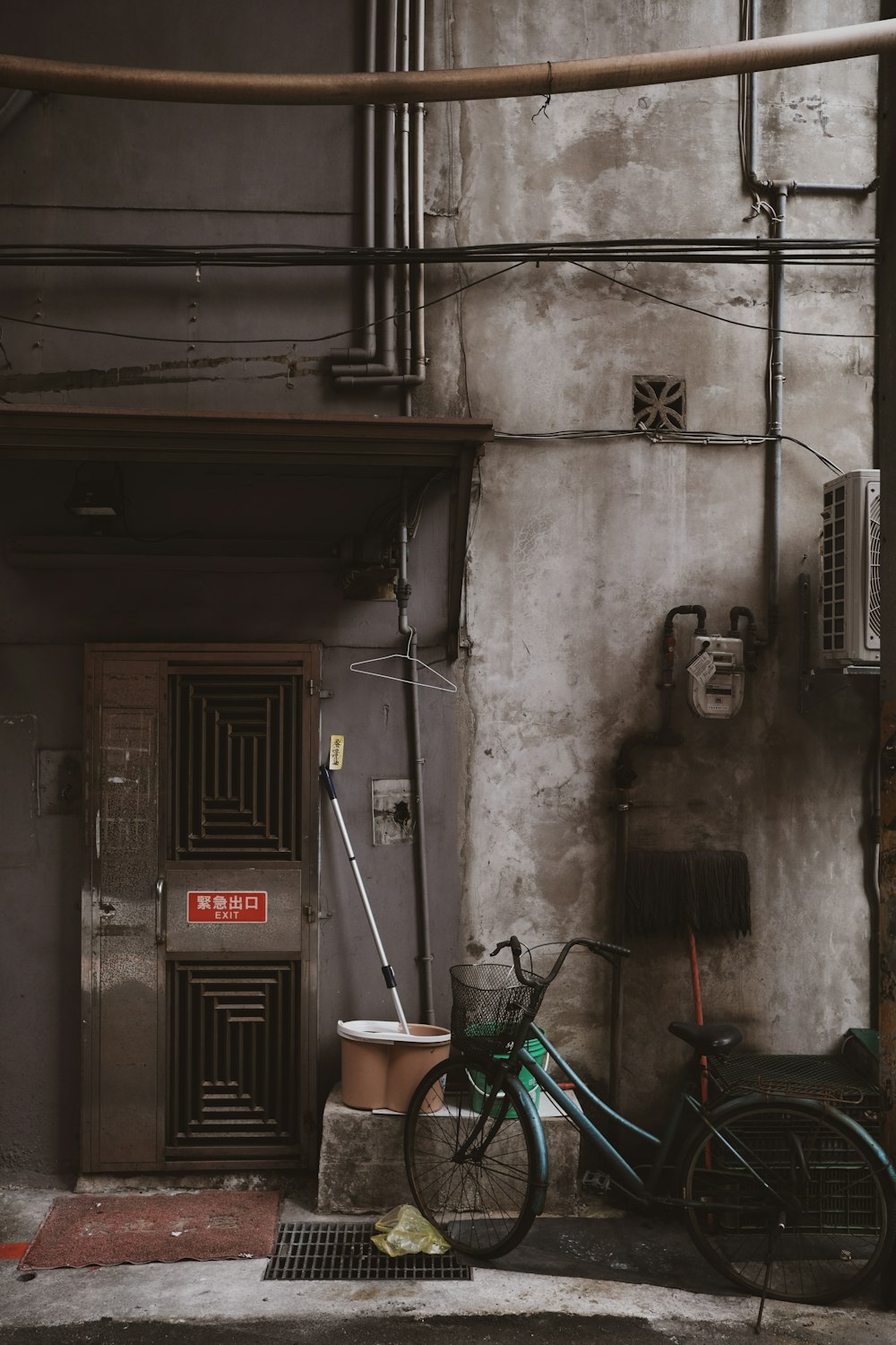 black wooden door near green plastic chair