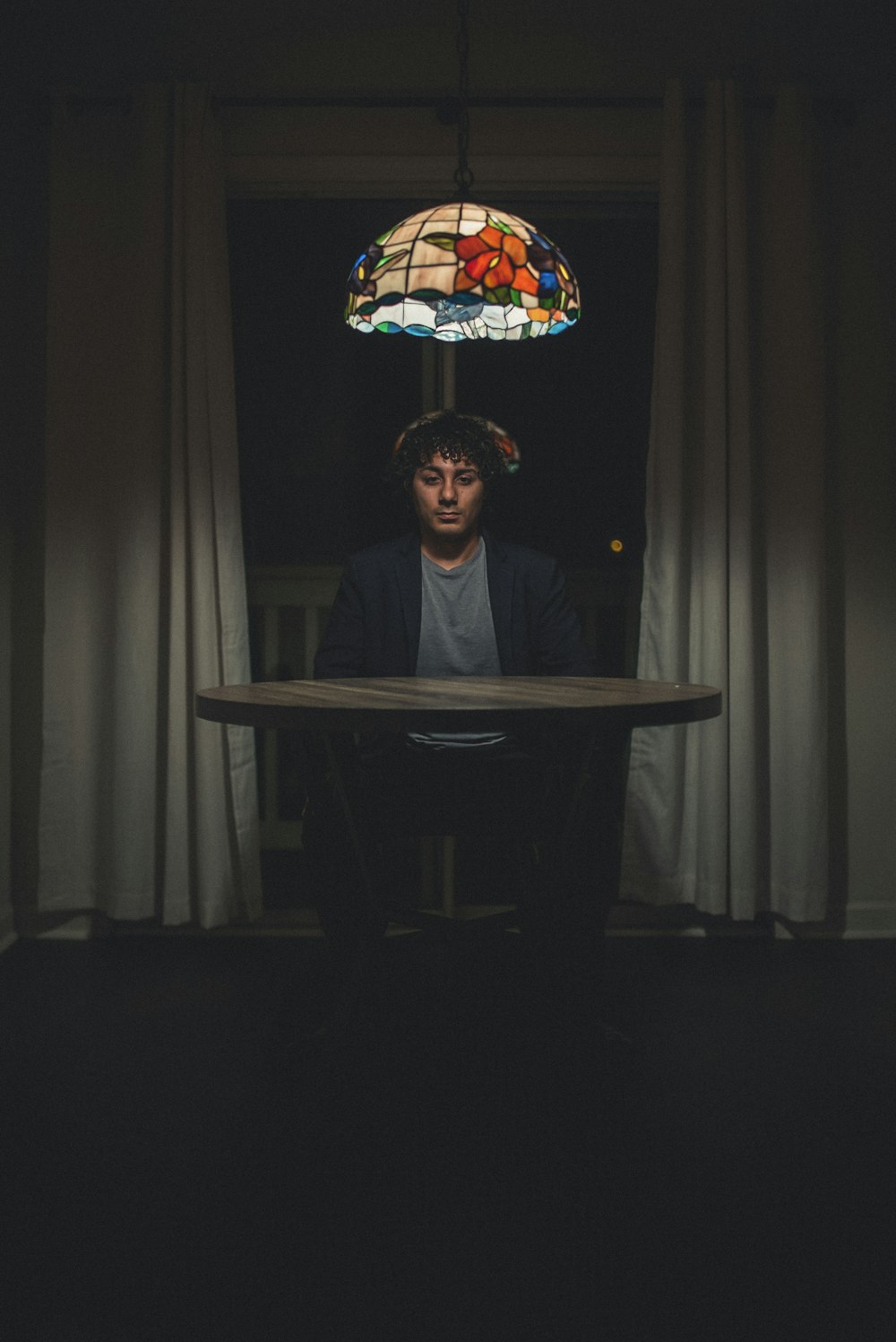 man in black jacket sitting on chair