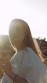 woman in white shirt looking at the sky during daytime