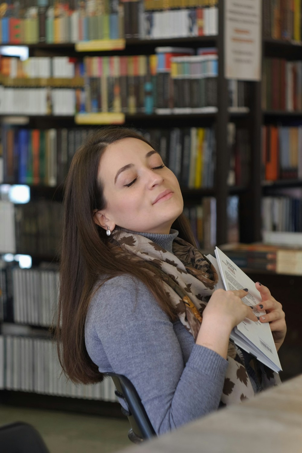 woman in gray long sleeve shirt reading book