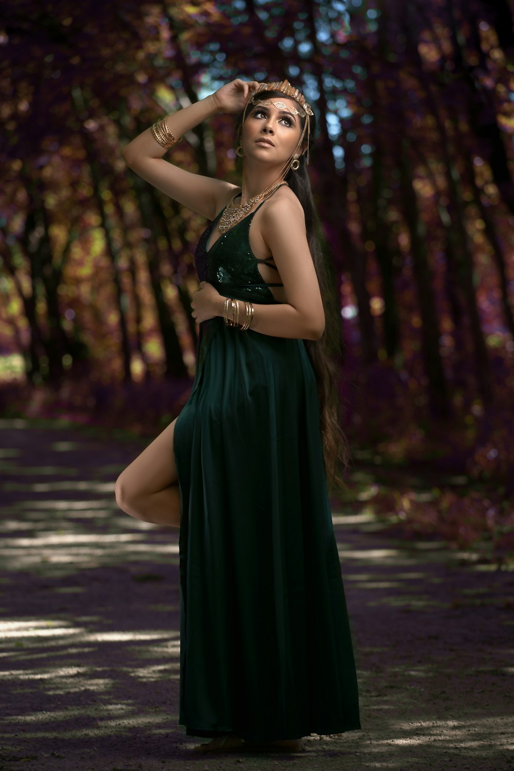 woman in green sleeveless dress standing on road during daytime