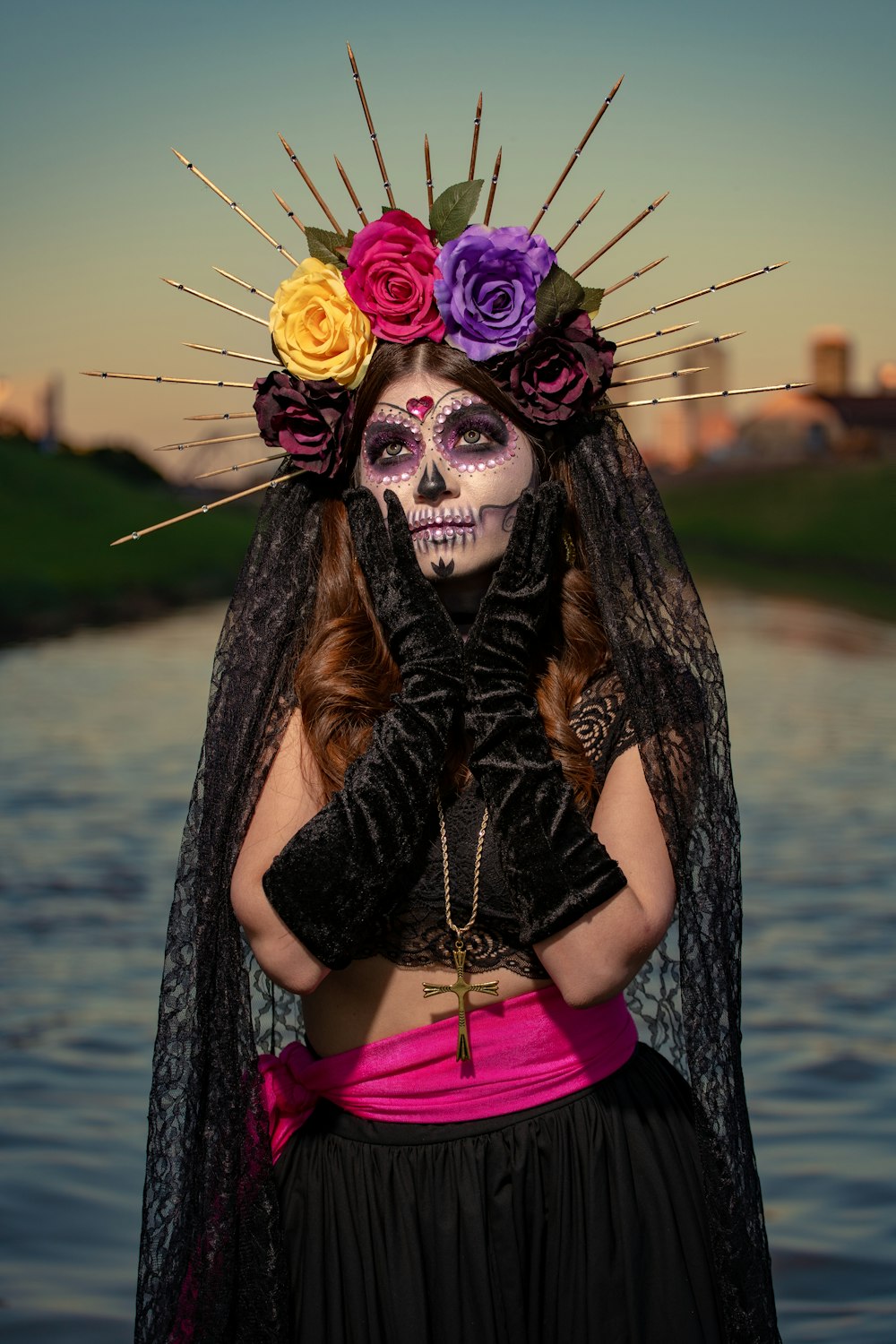 woman in black and pink long sleeve dress wearing black and purple feather headdress