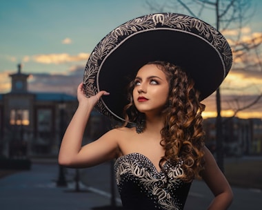 woman in black and white floral hat and black tube dress
