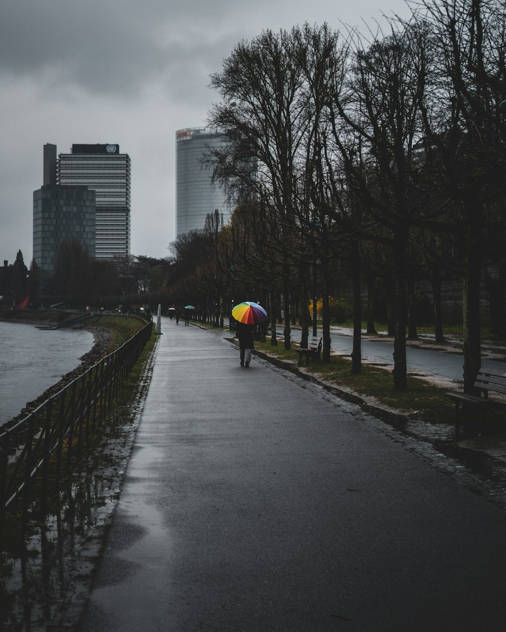 person in yellow jacket walking on sidewalk during daytime